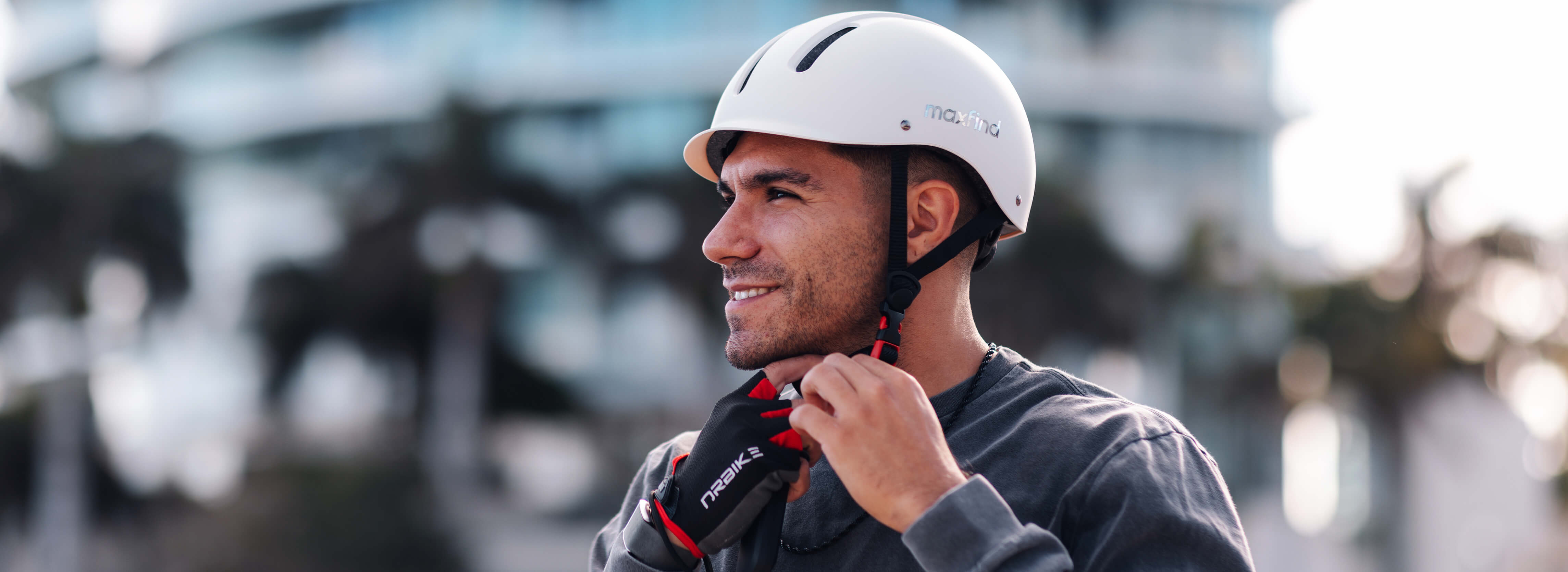 Man wearing a white helmet and gloves with a blurred background